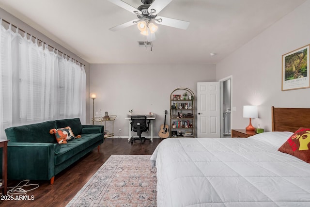 bedroom featuring visible vents, baseboards, ceiling fan, and wood finished floors