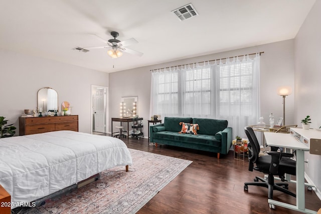 bedroom with visible vents, dark wood-type flooring, and a ceiling fan