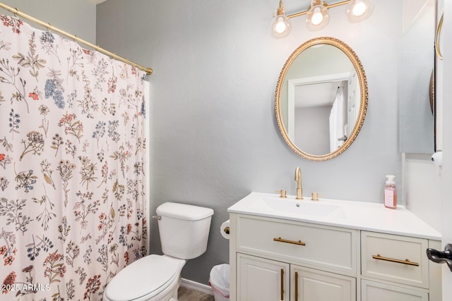 bathroom featuring curtained shower, toilet, and vanity