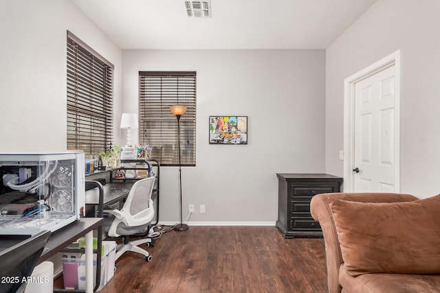 home office featuring visible vents, baseboards, and wood finished floors