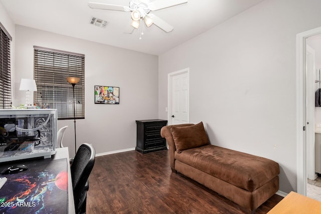 office area with baseboards, wood finished floors, visible vents, and ceiling fan