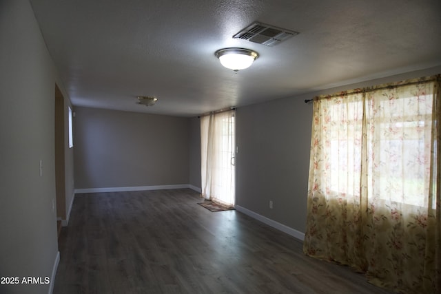 8334 N 55th Ave, Glendale, AZ 85302 - unfurnished room featuring wood finished floors, a textured ceiling, and baseboards