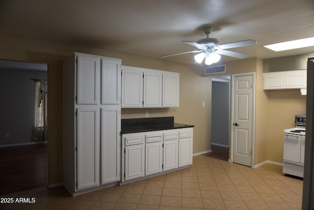 8334 N 55th Ave, Glendale, AZ 85302 - kitchen with white electric stove, a ceiling fan, white cabinetry, baseboards, and dark countertops