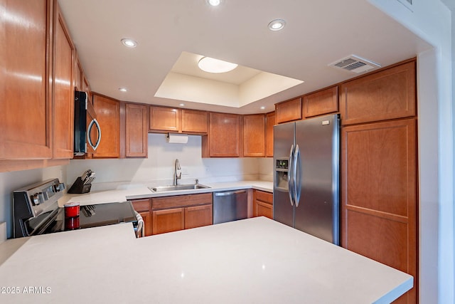 8414 N Central Ave Unit C, Phoenix, AZ 85020 - kitchen with stainless steel appliances, a sink, light countertops, a tray ceiling, and recessed lighting