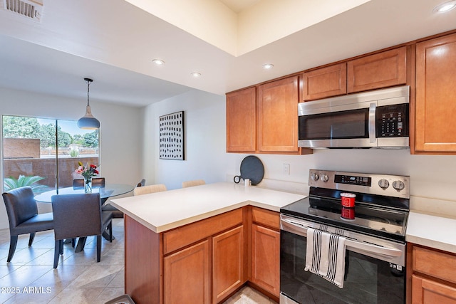 8414 N Central Ave Unit C, Phoenix, AZ 85020 - kitchen with appliances with stainless steel finishes, a peninsula, recessed lighting, light countertops, and pendant lighting