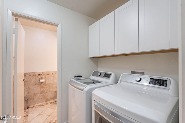 8414 N Central Ave Unit C, Phoenix, AZ 85020 - laundry room featuring cabinet space, washing machine and clothes dryer, tile walls, and a wainscoted wall
