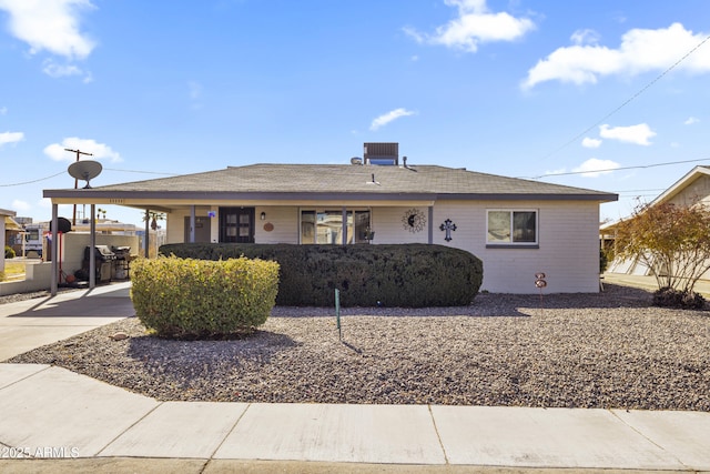 ranch-style house with a carport and central air condition unit