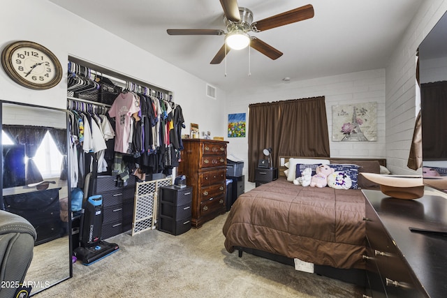 bedroom featuring ceiling fan, light colored carpet, and a closet