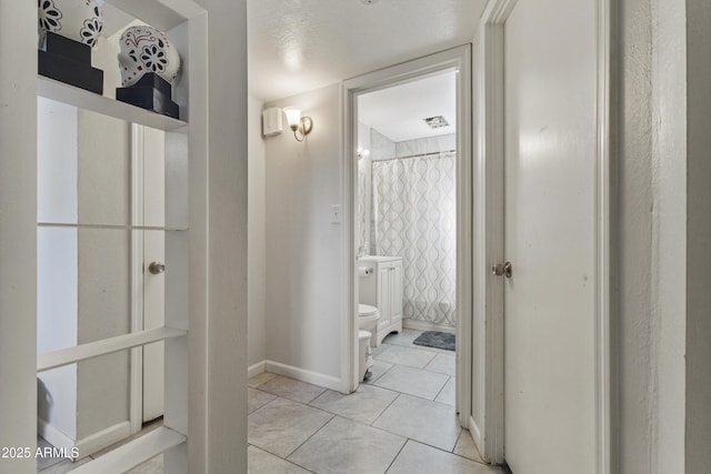 bathroom with tile patterned flooring, curtained shower, and toilet