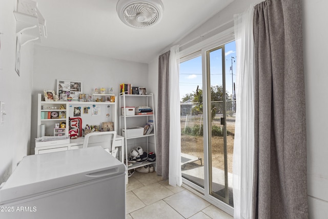 clothes washing area featuring light tile patterned floors