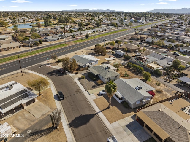 drone / aerial view featuring a water and mountain view