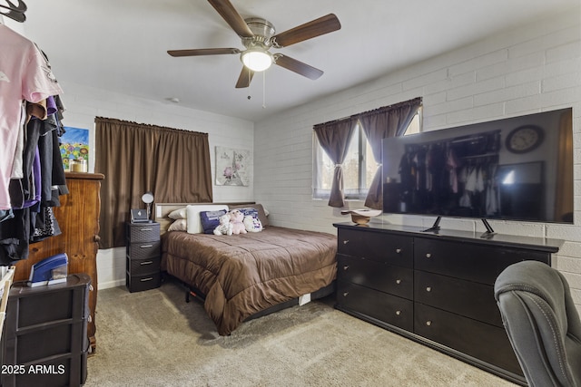 bedroom with brick wall, light carpet, and ceiling fan