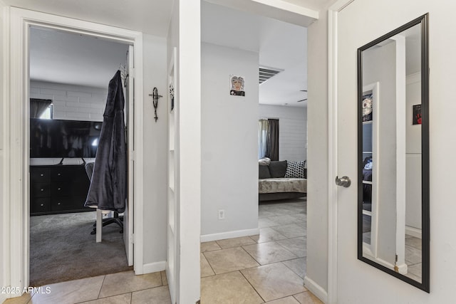 corridor with light tile patterned floors