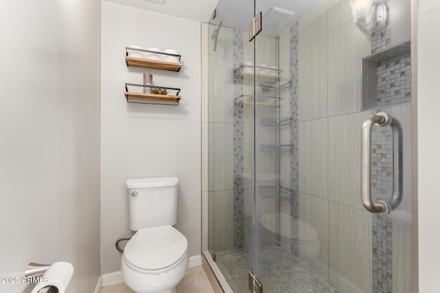 bathroom with toilet and a shower with door