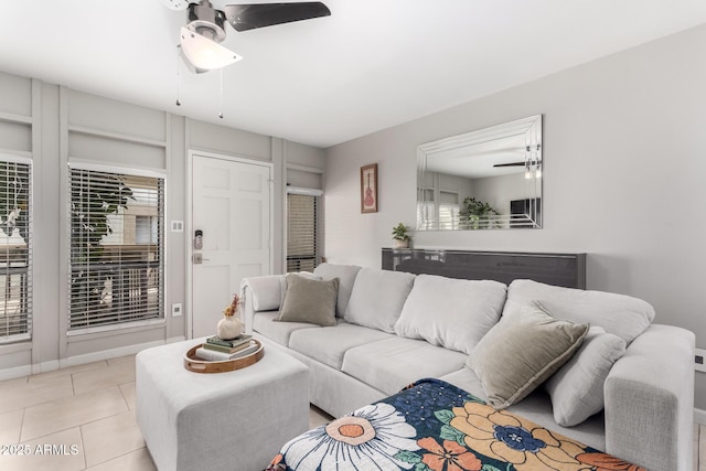 tiled living room with ceiling fan