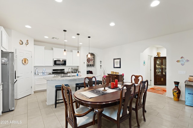 3655 N Astoria Dr, Florence, AZ 85132 - dining room featuring arched walkways, recessed lighting, and light tile patterned floors