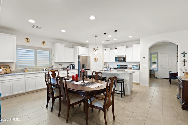3655 N Astoria Dr, Florence, AZ 85132 - dining space featuring plenty of natural light, recessed lighting, arched walkways, and light tile patterned flooring
