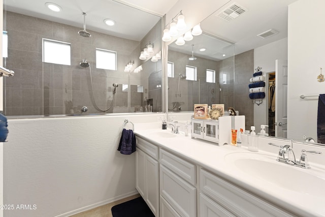 3655 N Astoria Dr, Florence, AZ 85132 - full bathroom with tiled shower, double vanity, and recessed lighting