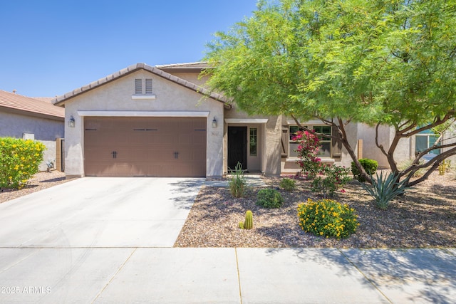 3655 N Astoria Dr, Florence, AZ 85132 - view of front facade with a garage, stucco siding, driveway, and a tiled roof
