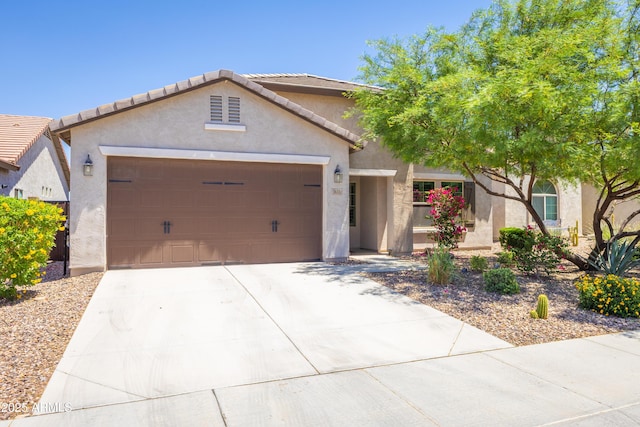 3655 N Astoria Dr, Florence, AZ 85132 - view of front of home featuring stucco siding, an attached garage, concrete driveway, and a tiled roof