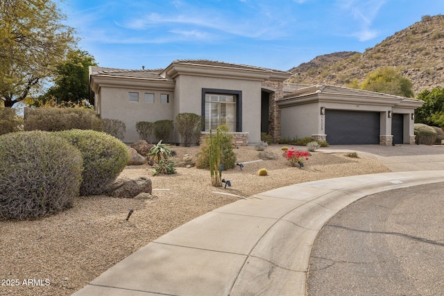 view of front facade with a mountain view and a garage