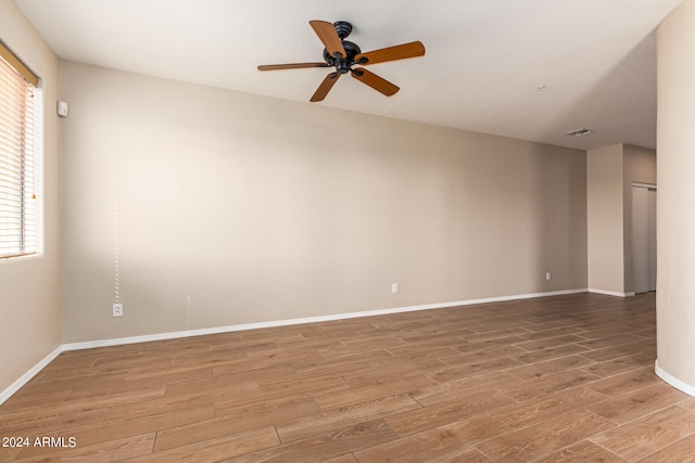 empty room with ceiling fan and hardwood / wood-style flooring