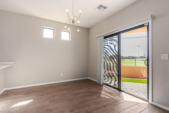 interior space featuring a notable chandelier and hardwood / wood-style flooring