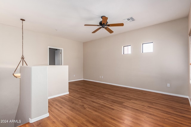 spare room featuring ceiling fan and dark hardwood / wood-style flooring