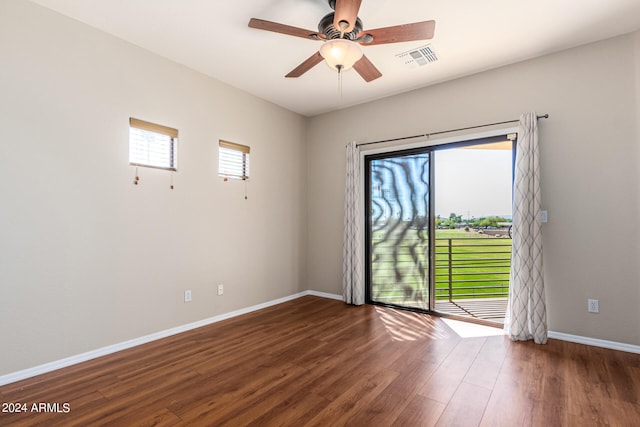 spare room featuring dark hardwood / wood-style floors and ceiling fan