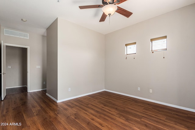 spare room with dark hardwood / wood-style floors and ceiling fan