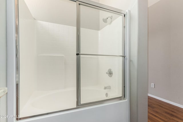 bathroom featuring combined bath / shower with glass door and hardwood / wood-style floors