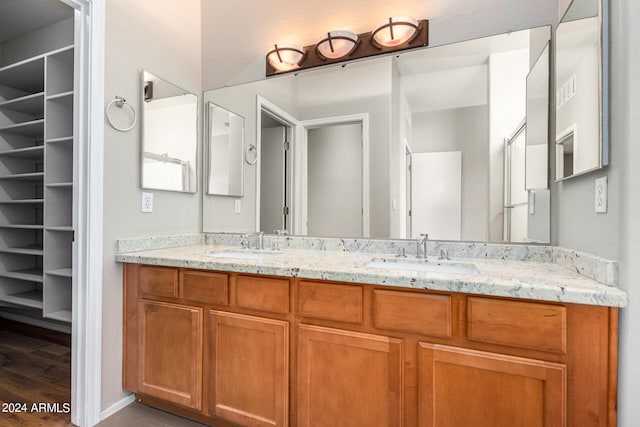 bathroom with vanity and hardwood / wood-style flooring