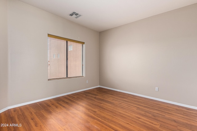 spare room with hardwood / wood-style flooring