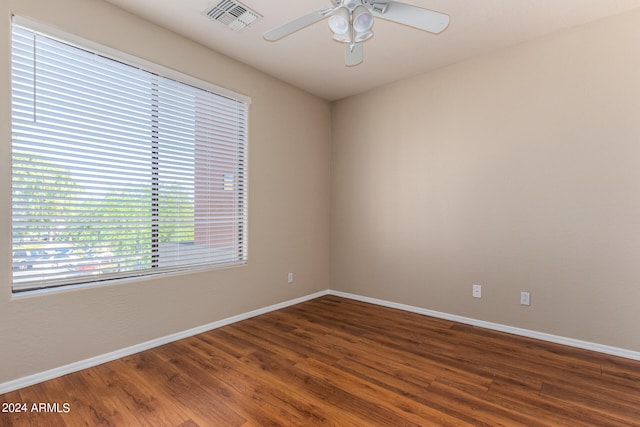 empty room with dark wood-type flooring and ceiling fan