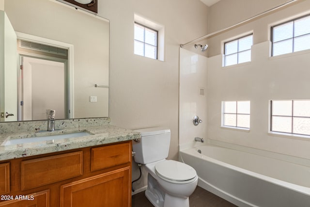 full bathroom featuring a healthy amount of sunlight, vanity, shower / washtub combination, and toilet