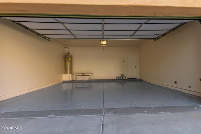 garage with a garage door opener and water heater