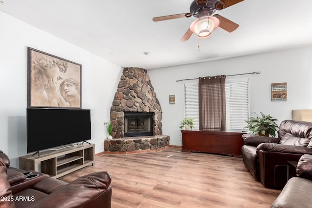 1730 W Adamanda Ct, Phoenix, AZ 85086 - living room featuring a ceiling fan, a fireplace, and light wood-style flooring