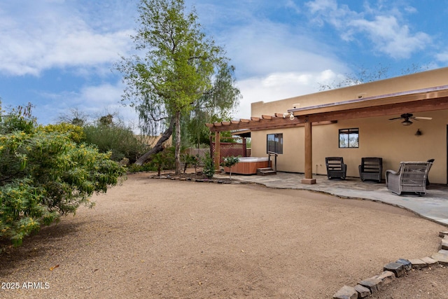 1730 W Adamanda Ct, Phoenix, AZ 85086 - back of house with a hot tub, ceiling fan, a patio area, stucco siding, and a pergola