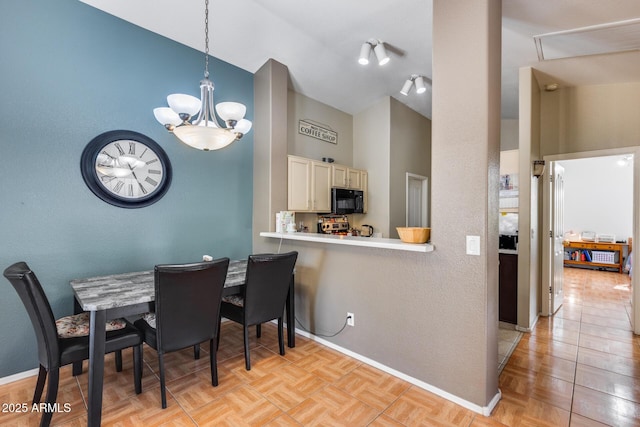 dining area featuring an inviting chandelier, high vaulted ceiling, and light parquet flooring