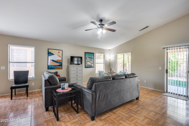 living room with lofted ceiling, ceiling fan, and light parquet flooring