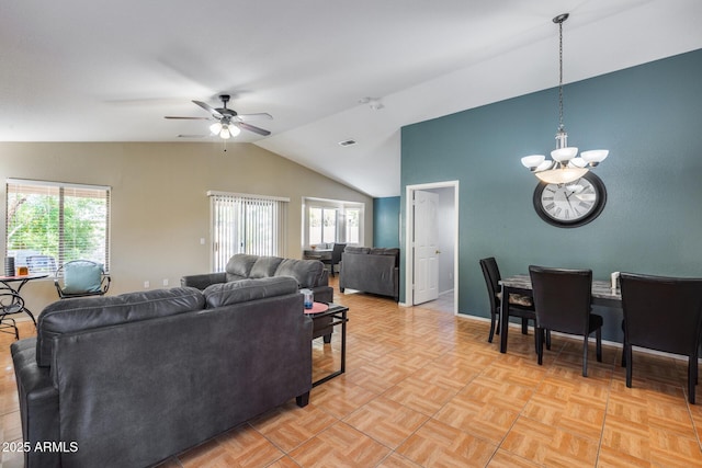 living room with light parquet floors, lofted ceiling, and ceiling fan with notable chandelier