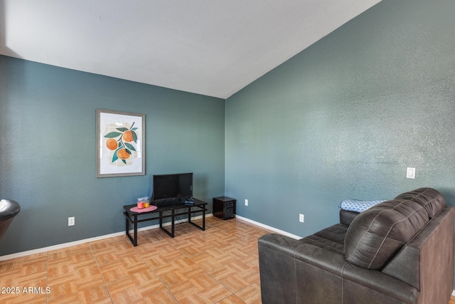 living room featuring lofted ceiling and light parquet floors