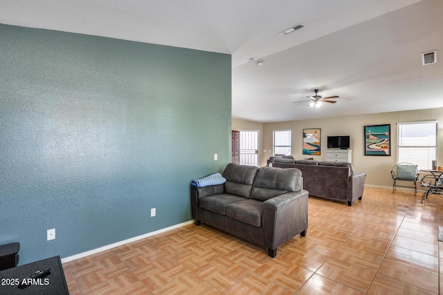 living room featuring light parquet floors, a wealth of natural light, and ceiling fan