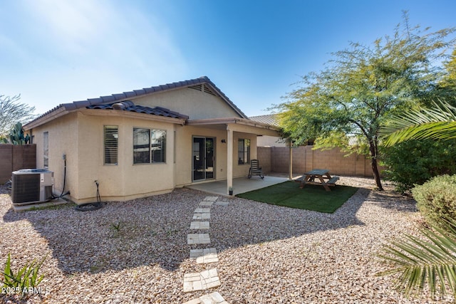 back of property featuring central AC unit and a patio area