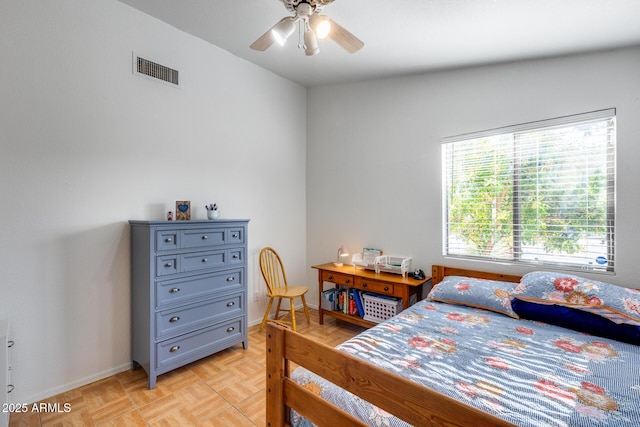 bedroom with light parquet floors and ceiling fan