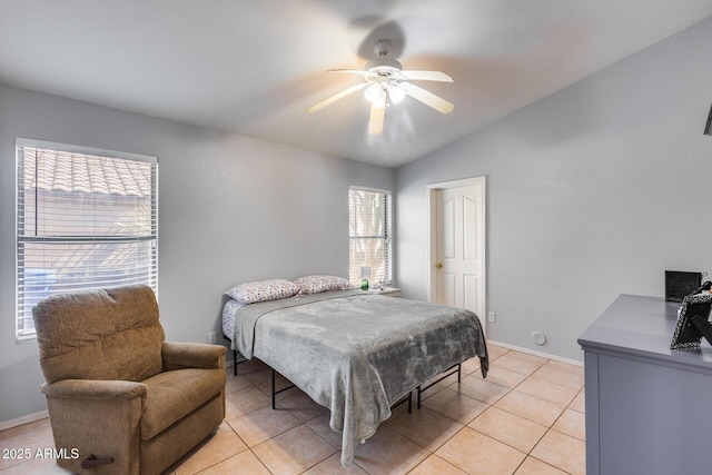 bedroom with ceiling fan, lofted ceiling, and light tile patterned floors