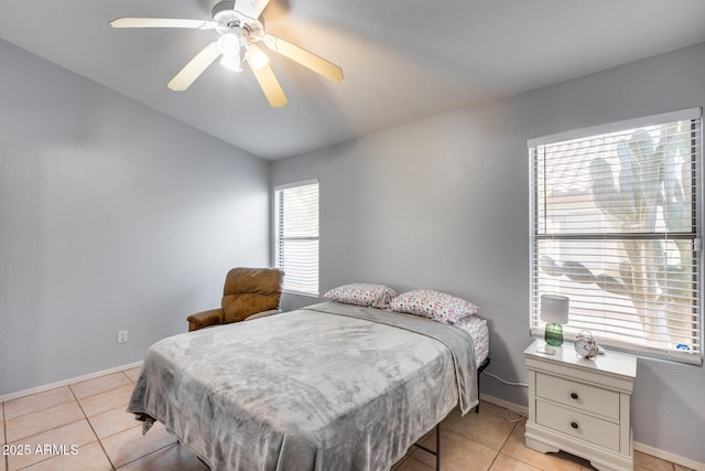 bedroom with light tile patterned flooring, vaulted ceiling, and ceiling fan