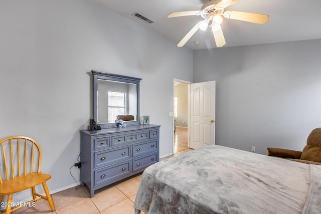 tiled bedroom featuring lofted ceiling and ceiling fan