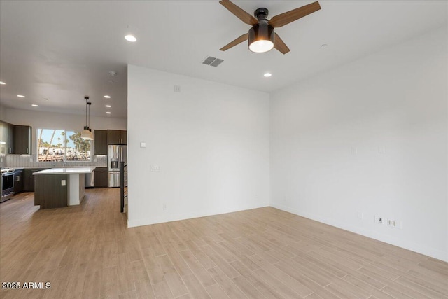 1717 E Morten Ave Unit 2, Phoenix, AZ 85020 - unfurnished living room featuring ceiling fan and light hardwood / wood-style floors