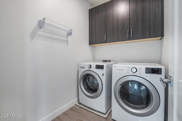1717 E Morten Ave Unit 2, Phoenix, AZ 85020 - washroom featuring washer and clothes dryer, cabinets, and hardwood / wood-style floors